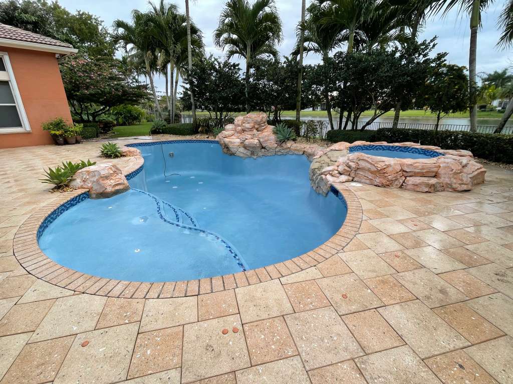 Pool with natural rock waterfall water feature